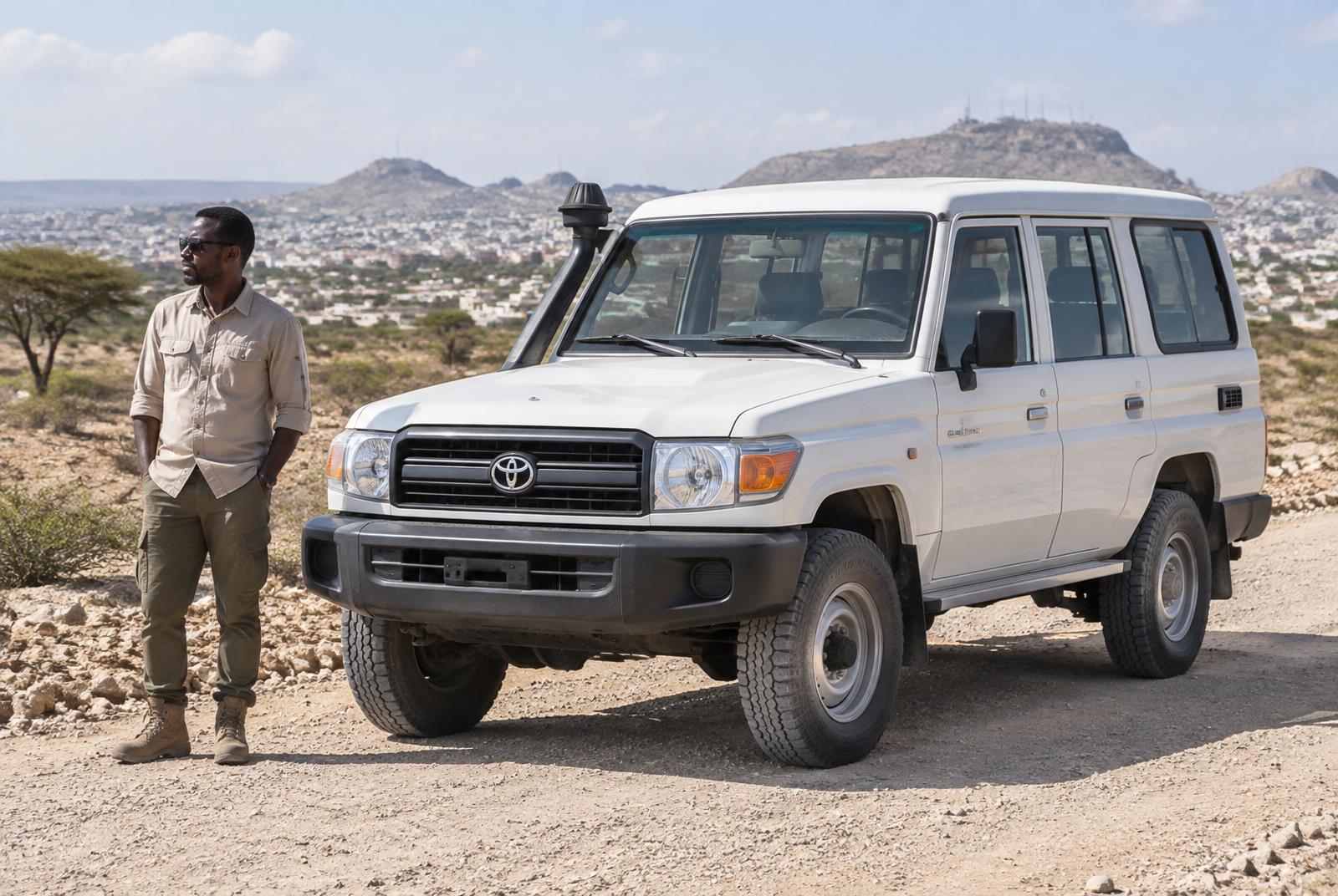 White Toyota Land Cruiser 4x4 with a driver on a road outside Hargeisa, Somaliland